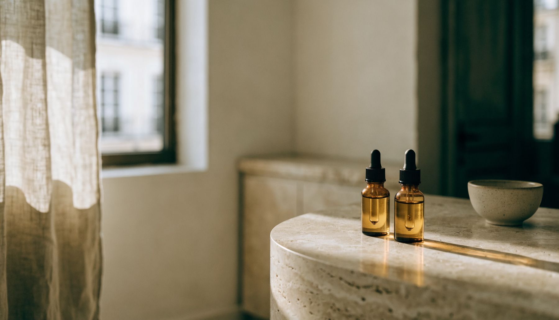 Sunlit studio with serum bottles on a stone counter